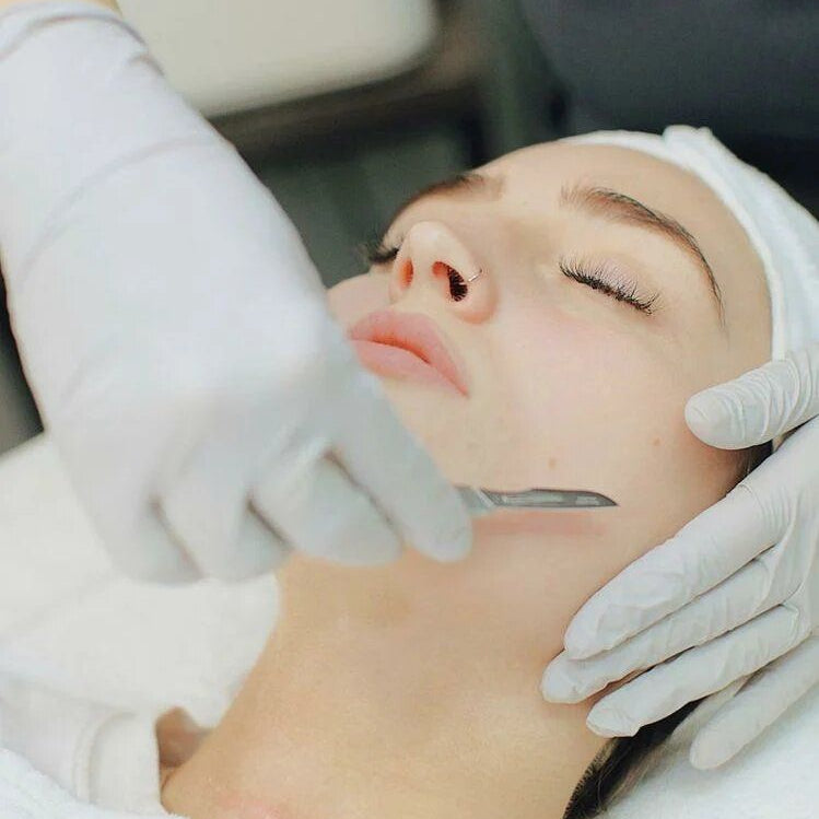 Person receiving a facial treatment with gloved hands
